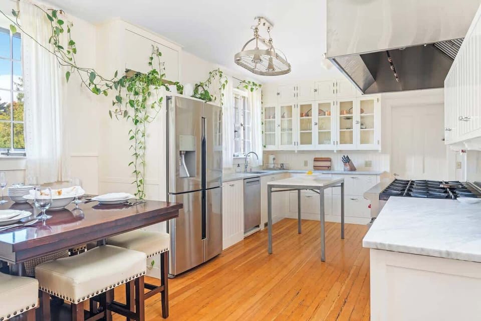 Our light filled eat-in kitchen has marble countertops, a Wolf stove with 10 gas burners and 2 large ovens, and upper cabinets & hardware original to the 1920s house.  Zwilling knives, Burlap & Barrel spices, and a full batterie du cuisine. 