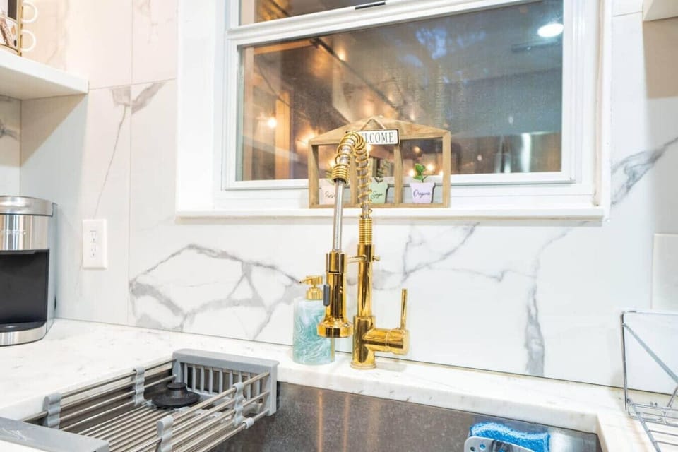 Wash up in style with this luxurious gold faucet and marble accents.