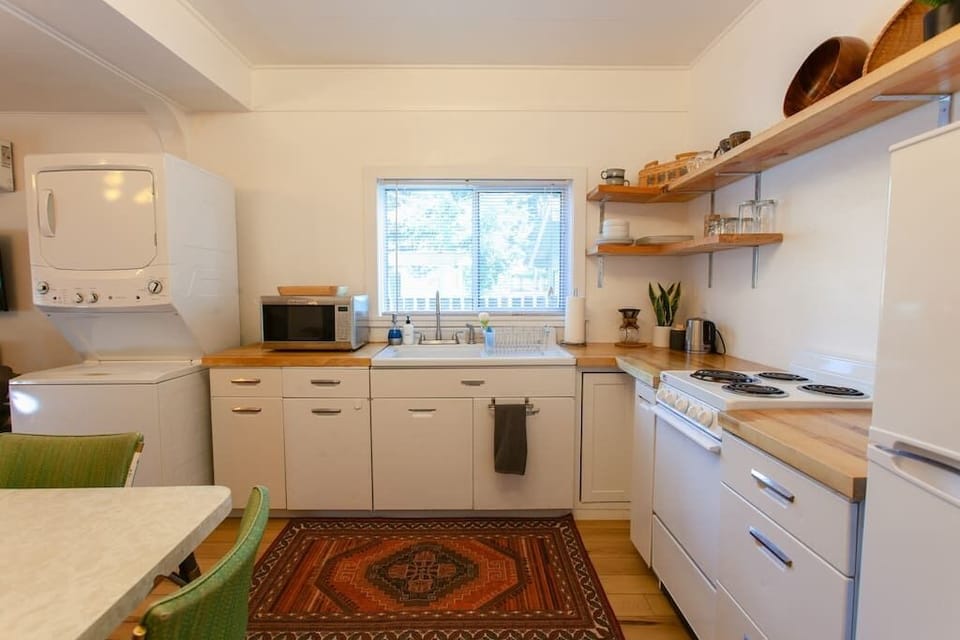 Bright kitchen with modern appliances and a cozy rug.