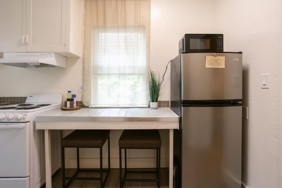 Compact and bright kitchen with a modern dining setup.