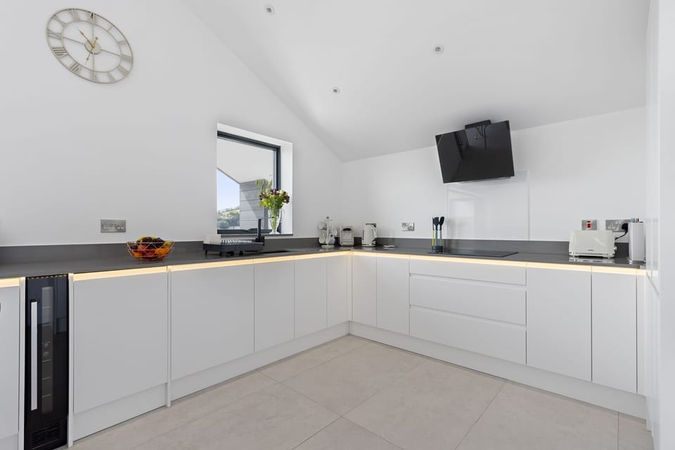 Open plan kitchen with AEG electric oven, microwave and integrated fridge & freezer