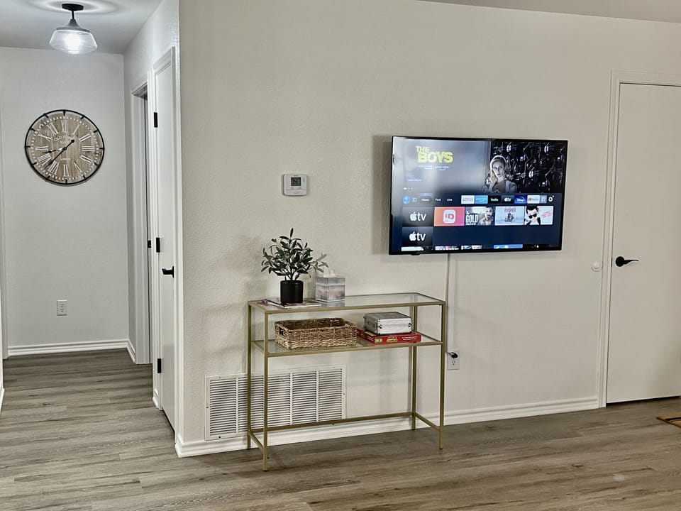 Cozy living room features queen memory foam mattress sleeper sofa & 50" Smart TV