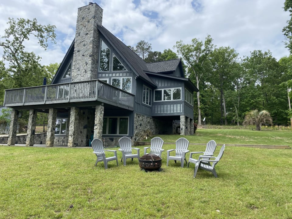 Lovely deck with grill and table up top.  Patio below. Firepit onsite as well