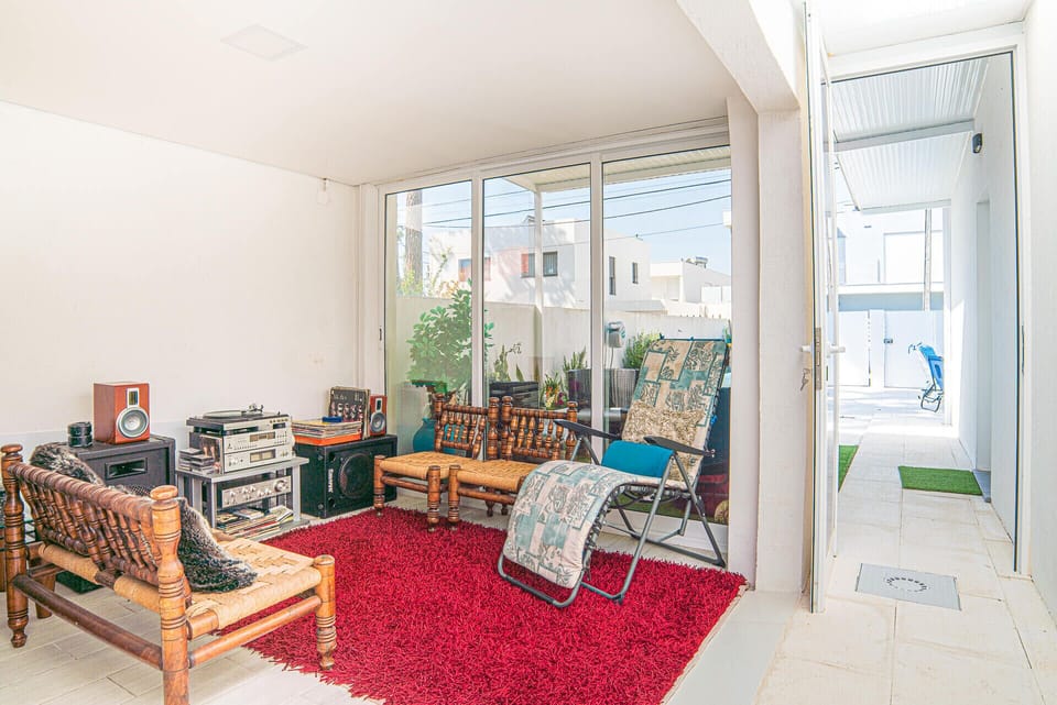 Vintage-style living room with red rug and wooden furniture — Villa Santi, holiday villa in Aroeira