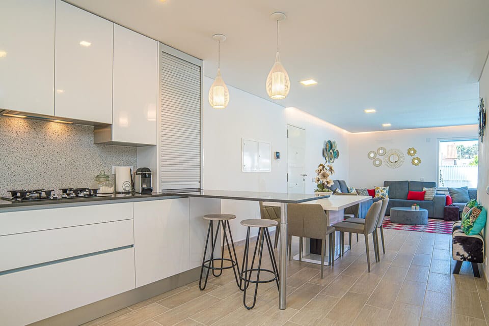 Open-plan kitchen and living area with pendant lighting — Villa Santi, luxury holiday villa in Aroeira