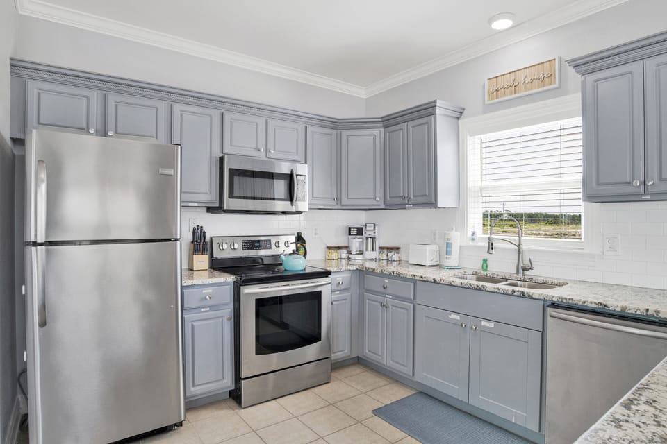 Modern appliances meet coastal charm in this airy kitchen