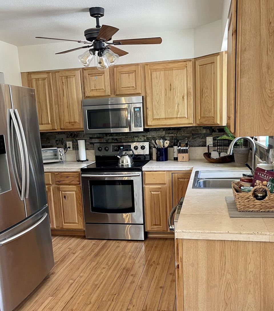Stainless steel appliances in kitchen, fridge with filtered water and ice