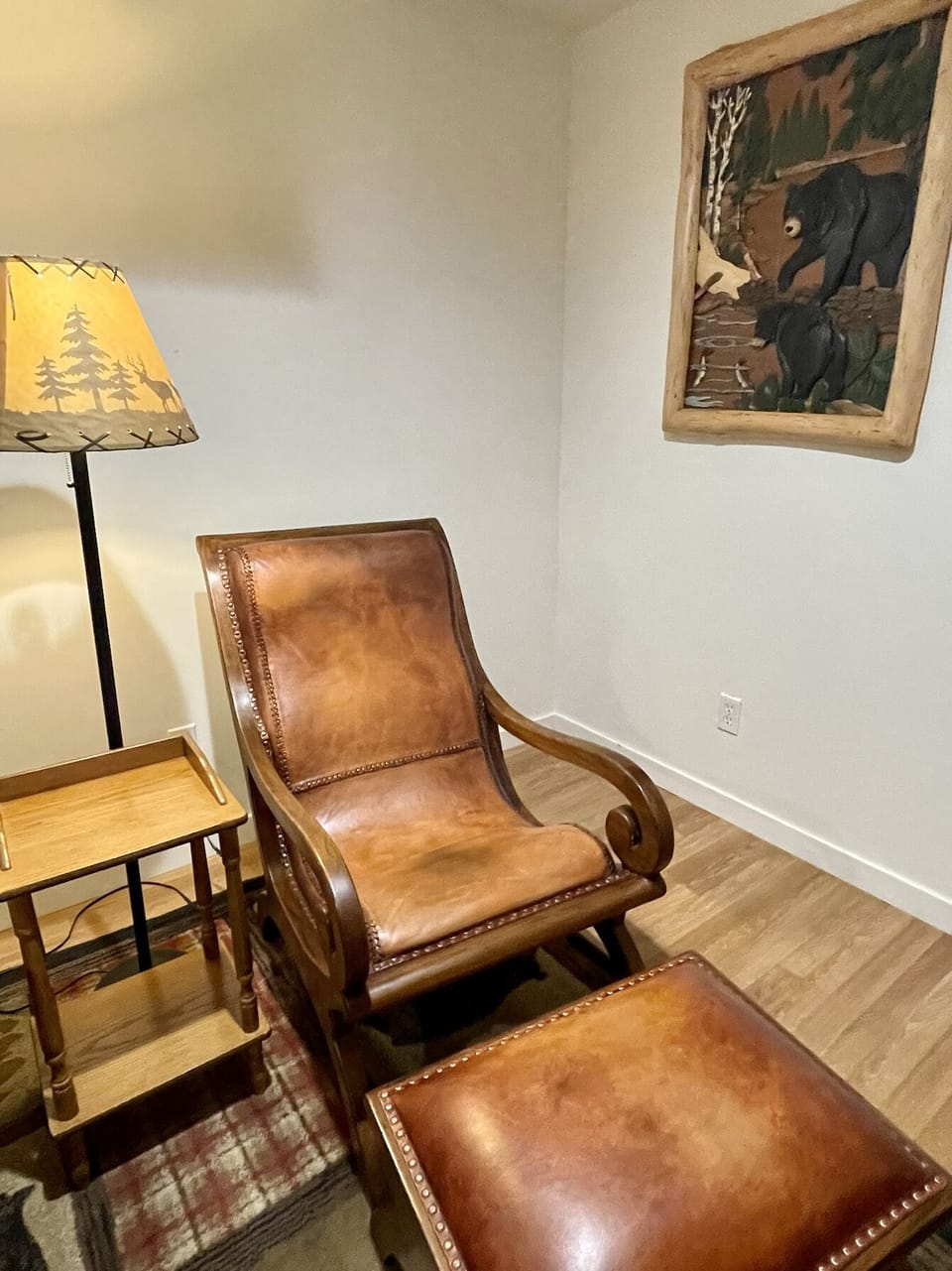 2 comfy Leather recliners with footrests surround the futon for Smart TV room 