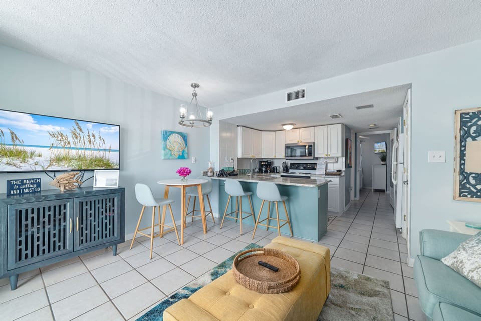 Enjoy an open living space complete with a well-equipped kitchen, a casual breakfast bar, and a comfortable entertainment area. The modern decor and thoughtful layout maximize the space, creating a perfect retreat for your getaway.