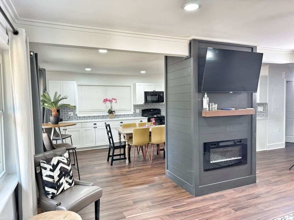 Open living area with smart TV and fireplace—gather in comfort.
