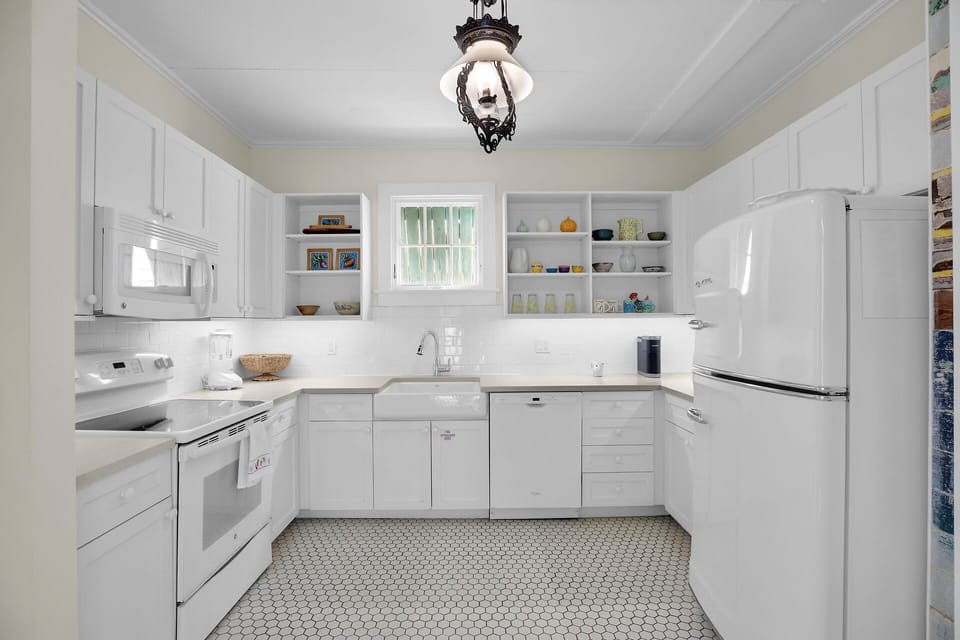 Crisp clean kitchen with retro fridge and plenty of storage!