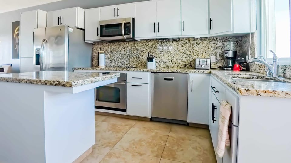 The kitchen is well-equipped with granite countertops (microwave is out of order)