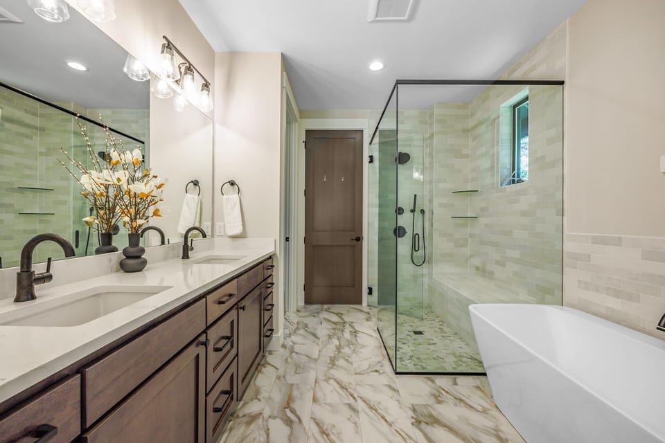 Master Suite En Suite Bathroom 1 - Spa-style ensuite with walk-in glass shower, soaking tub, and dual-sink vanity