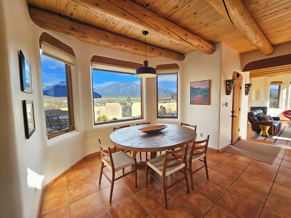 Dining area view from Kitchen looking towards mountains and outdoor dining area.
