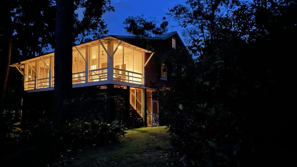 Pinetop Porch just as the sun drops below the horizon. Our home was designed by local architect Douglas Kearly for his parents summer home.
