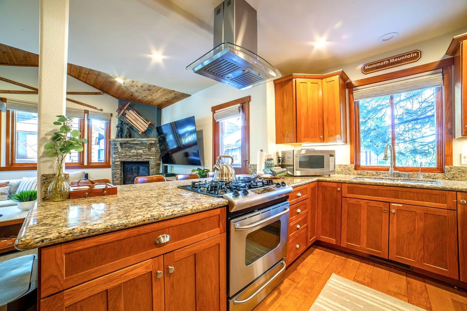 Open kitchen with solid granite countertops and custom cabinetry.