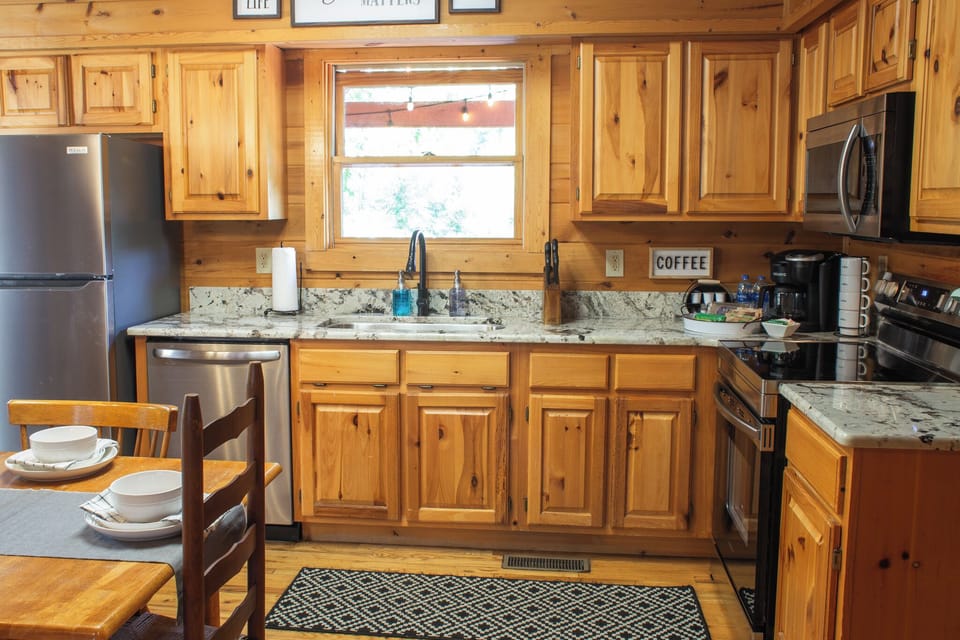 Brand new stainless steel appliances in the fully stocked kitchen.