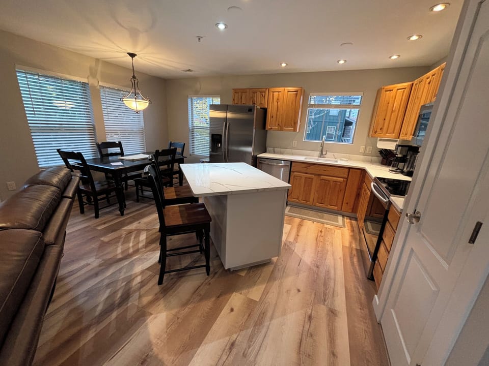 View of the fully equipped kitchen with quartz countertops and Island