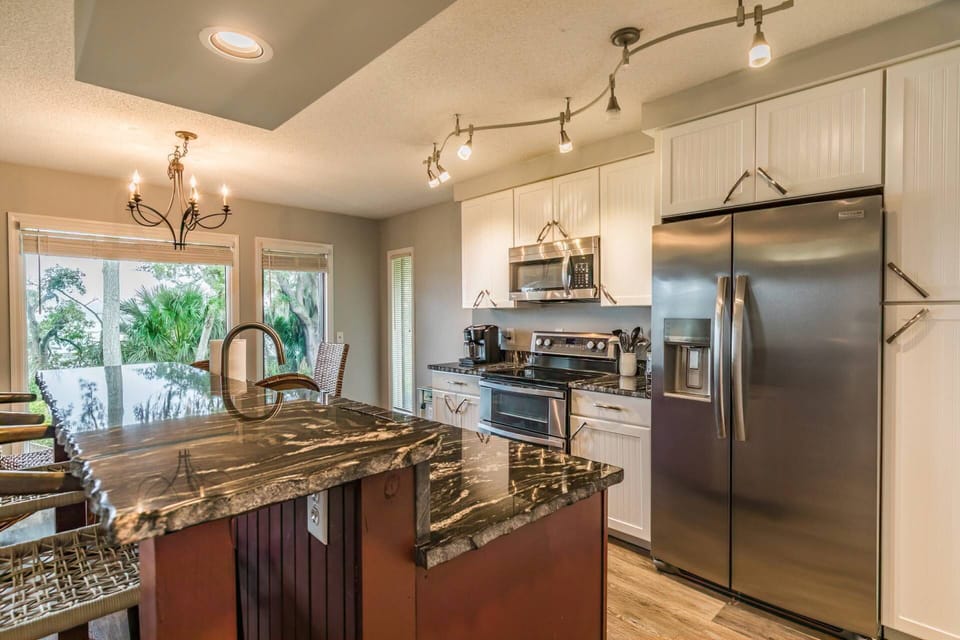 Kitchen island features additional seating for meals and snacks