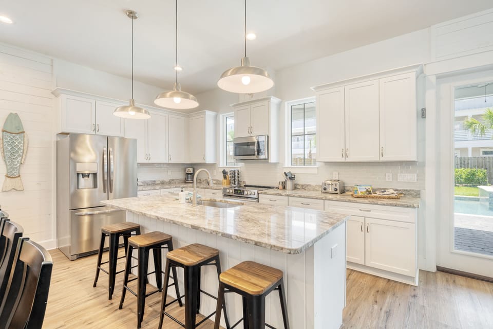 Modern kitchen with a huge fridge and stainless steel appliances.
