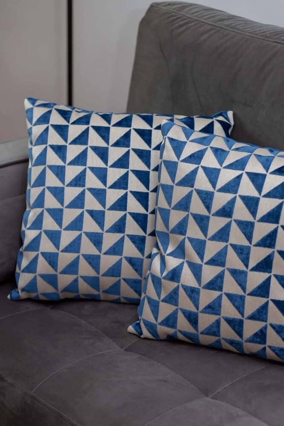 Decorative pillow with a geometric blue and white pattern adding a stylish accent.
