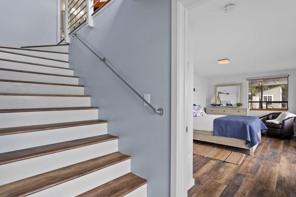 Stairs leading to 2nd bedroom, 3rd bedroom, additional bathroom and laundry.