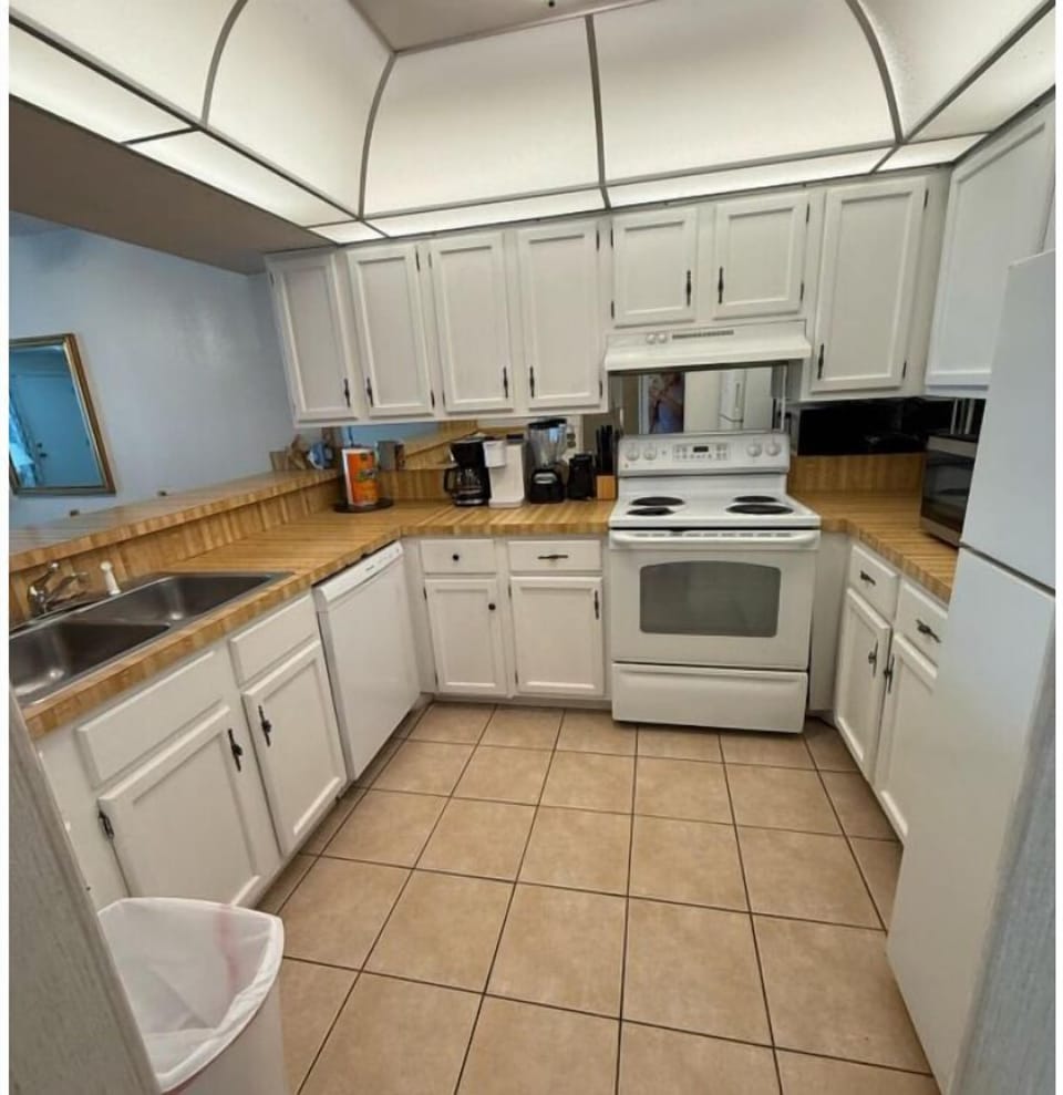 The equipped kitchen also boasts high bar seating for three (3) right next to the dining table.