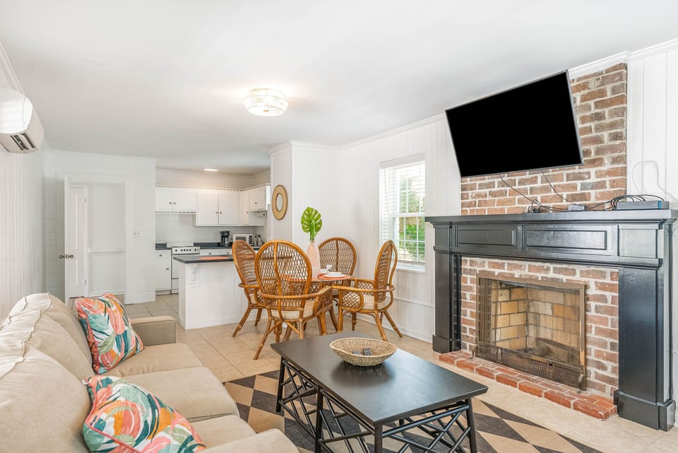 View of first floor living area with full kitchen, Smart Tv, breakfast area.