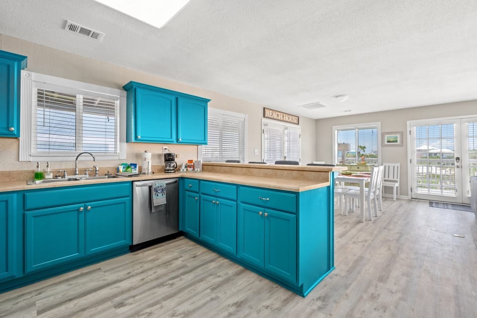 The kitchen flows into a cozy dining area for 6, perfect for meals together