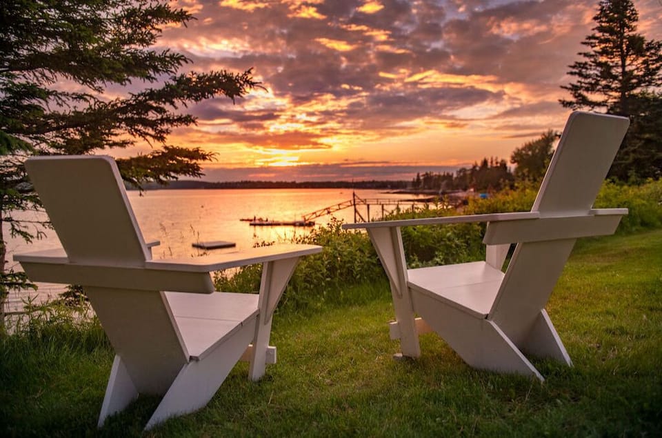 Escape for the ultimate getaway as golden skies melt into calm harbor waters.