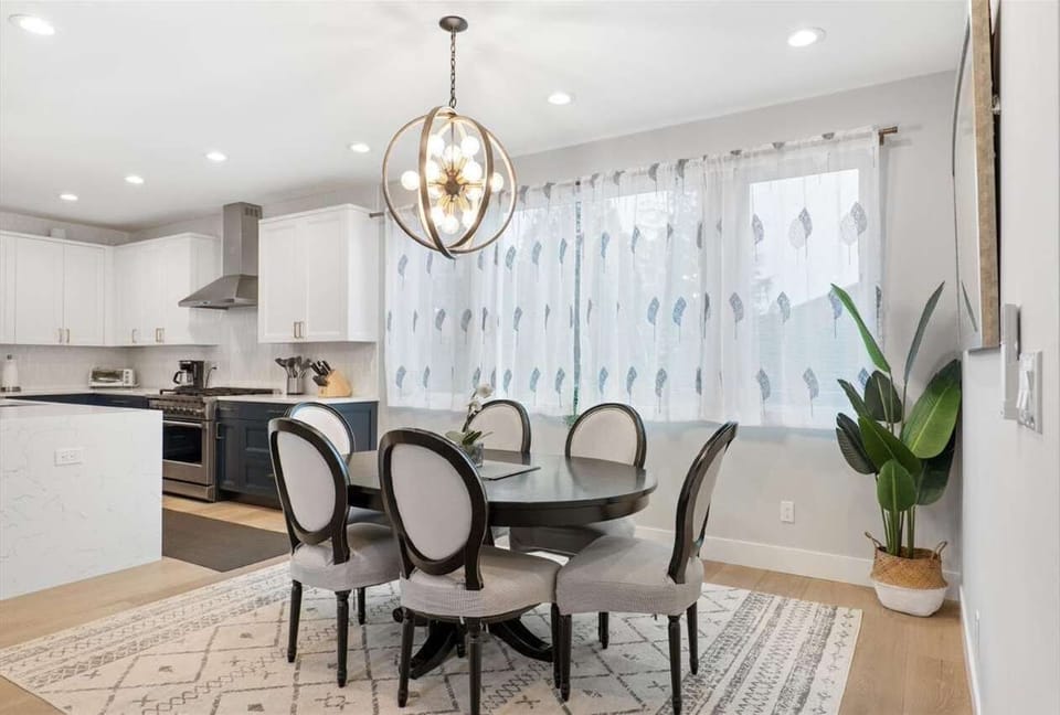 An inviting open layout seamlessly blends the living, kitchen, and dining areas—complete with elegant furnishings—creating a warm and connected space perfect for gathering and making memories.