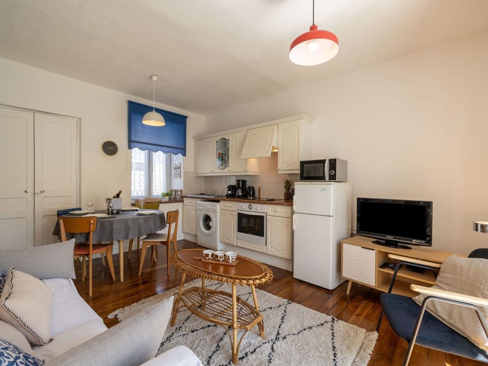 Furniture, Property, Cabinetry, Home Appliance, Interior Design, Television, Lighting, Wood, Chair, Kitchen