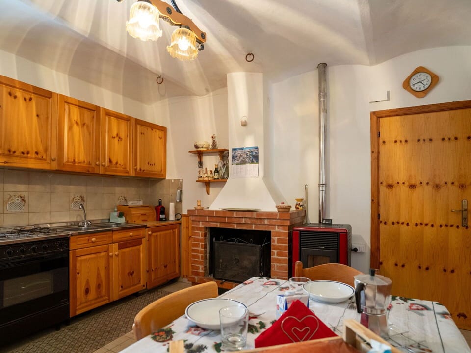 Furniture, Kitchen, Interior Design, Wood, Ceiling, Room, Light Fixture, Cabinetry, Major Appliance, Kitchen Appliance