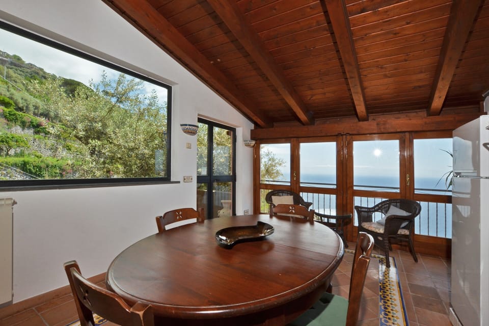 The bright kitchen dinin room with a nice and wide view on the sea