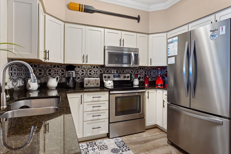 Updated cabinetry, stainless steel appliances, tile backsplash, under-cabinet lights and more!