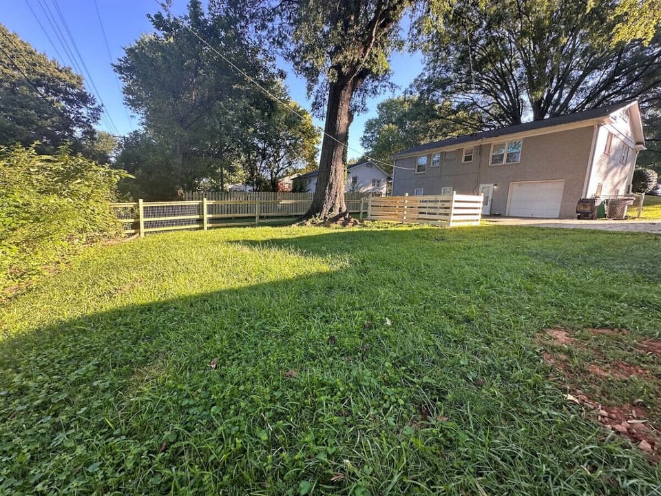 Expansive green yard with mature trees — one of the most spacious lots near Uptown Charlotte