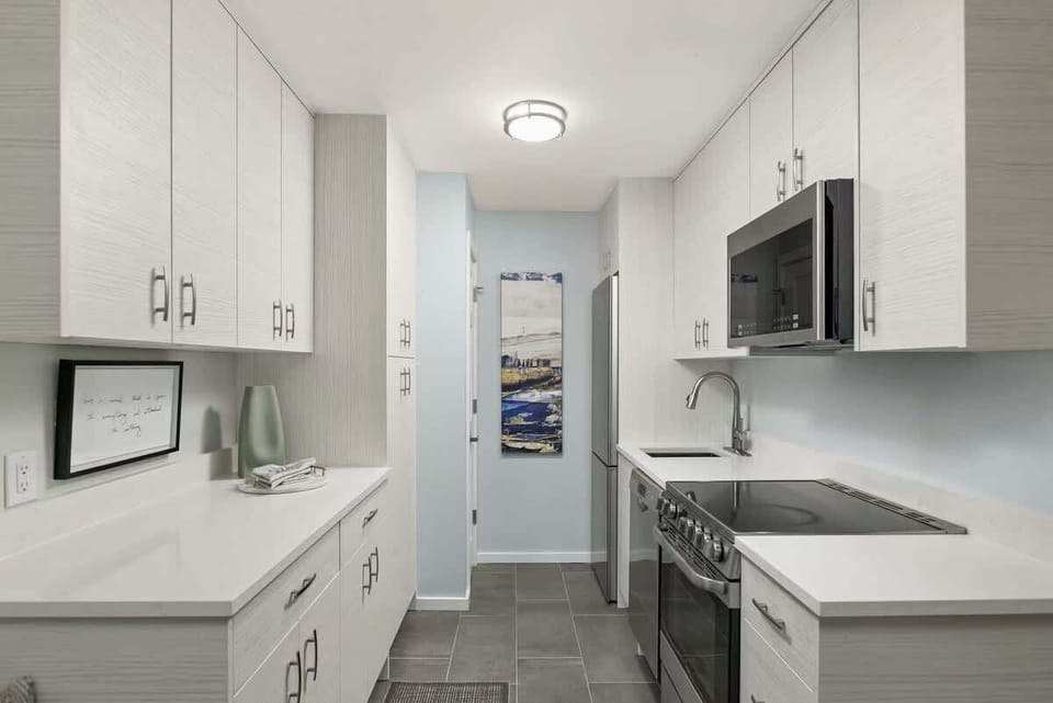 Fully appointed kitchen with quarts countertops and updated cabinets providing ample storage. 