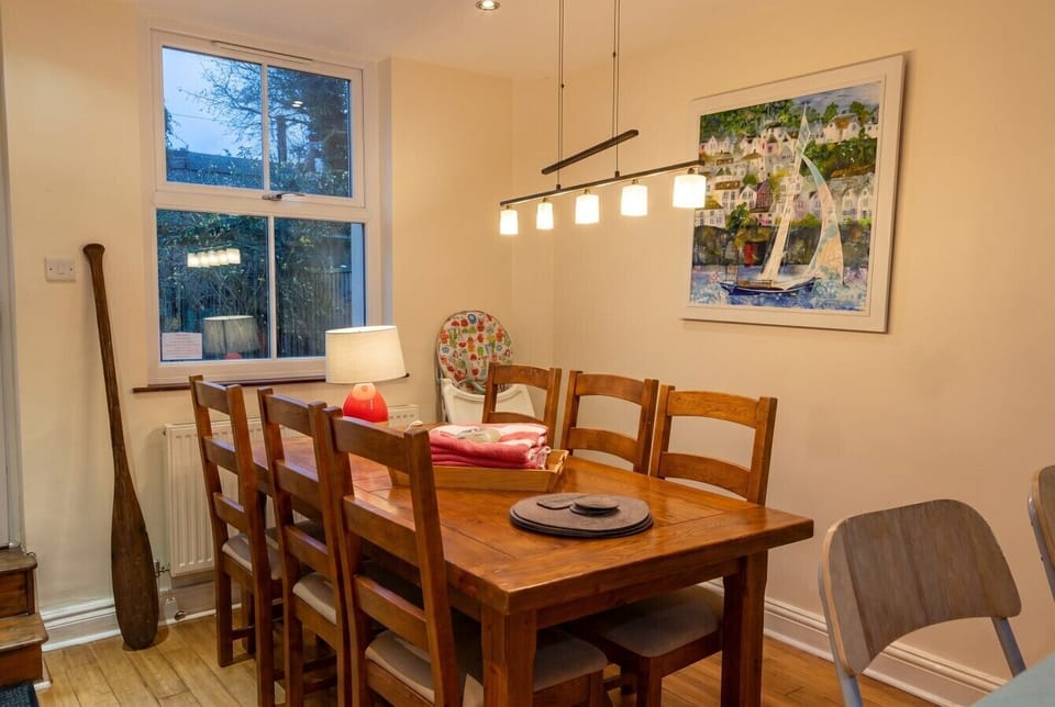Family friendly dining nook with high chair and coastal artwork.