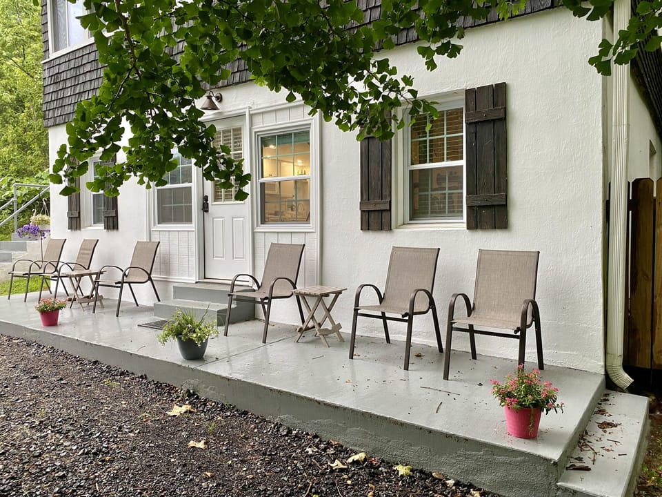 The front porch overlooks the stream and forest and is a step from parking.
