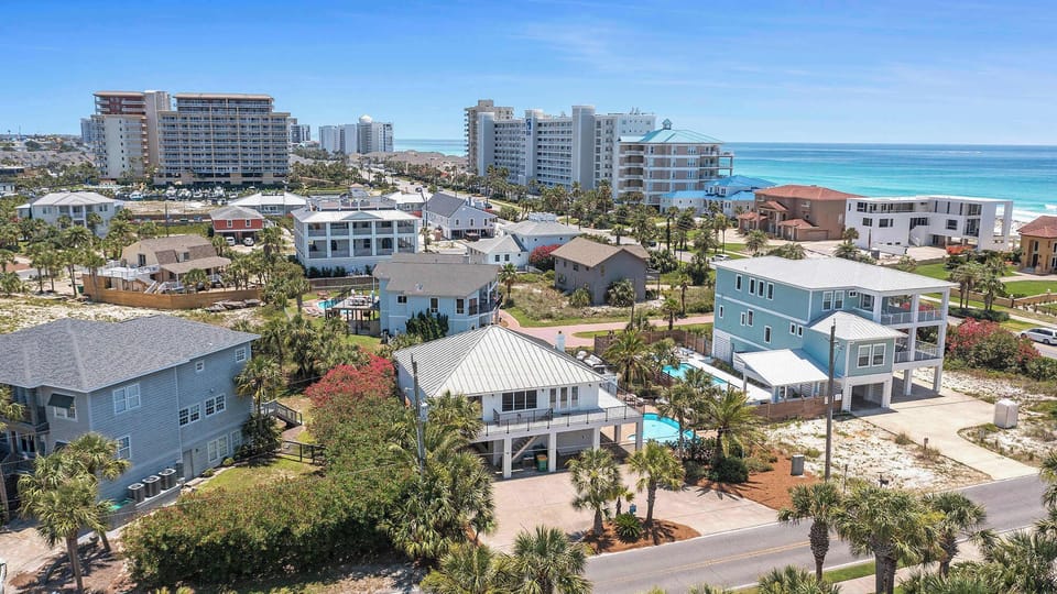 Elevated neighborhood view w/ rooftops, streets, & a coastal vibe