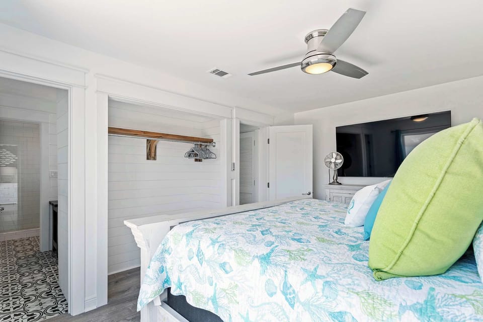 Comfortable bedroom w/ ceiling fan, crisp linens, & a calm vibe