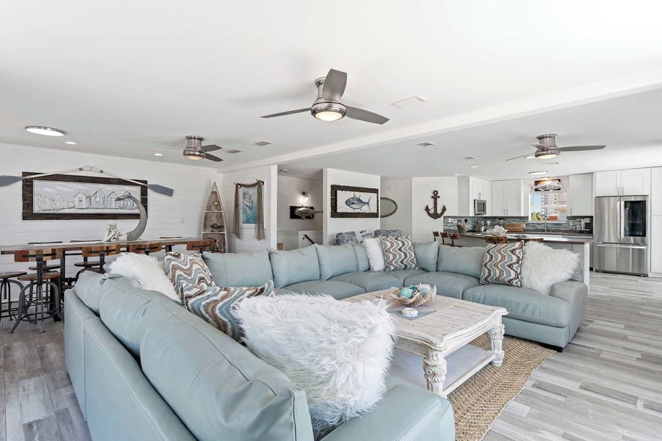 Bright living room w/ plush seating, coastal accents, & an open, relaxed layout