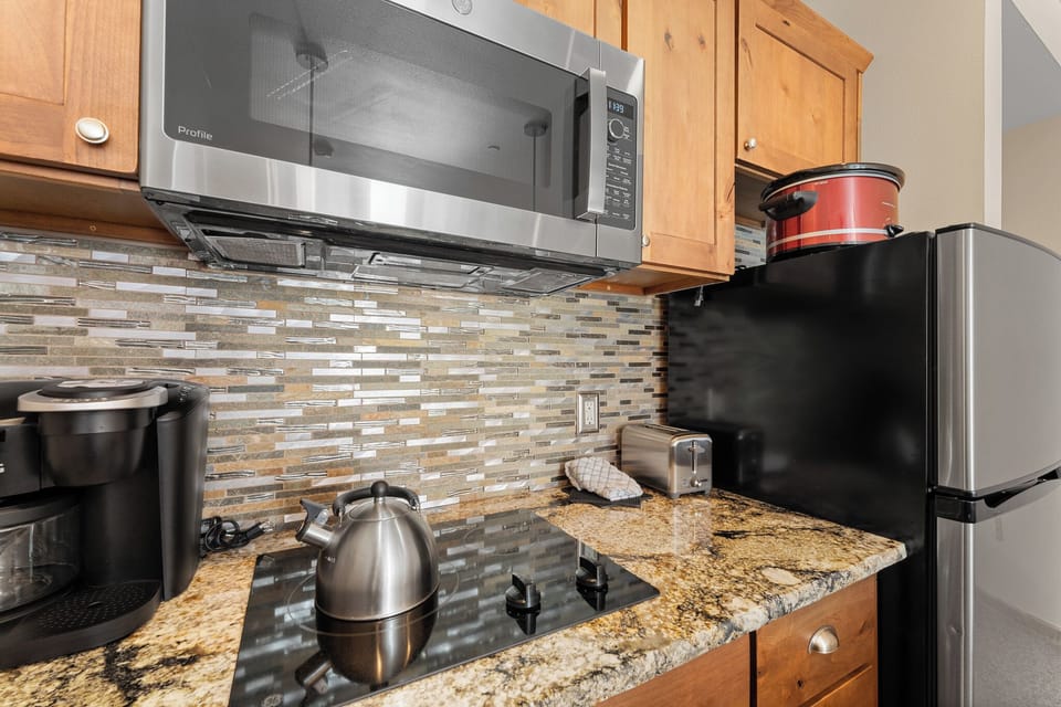 Your fully equipped kitchen awaits with granite counters, modern appliances, and everything needed to prepare meals during your stay.