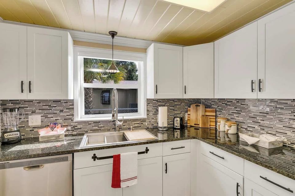 Beautifully clean & spacious kitchen with all new appliances! Stocked with everything you need for your stay & then some! Pots, pans, utensils, plates, bowls, wine glasses, coffee mugs, cups, blender, toaster, Keurig Duo k-cup & coffee maker & more!