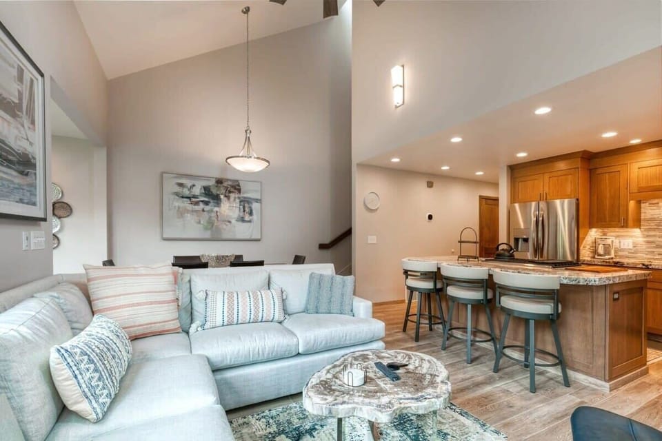 The vaulted ceilings and abundant windows add a bright and airy feel to this stunning home, which features an open-concept living, kitchen and dining area.