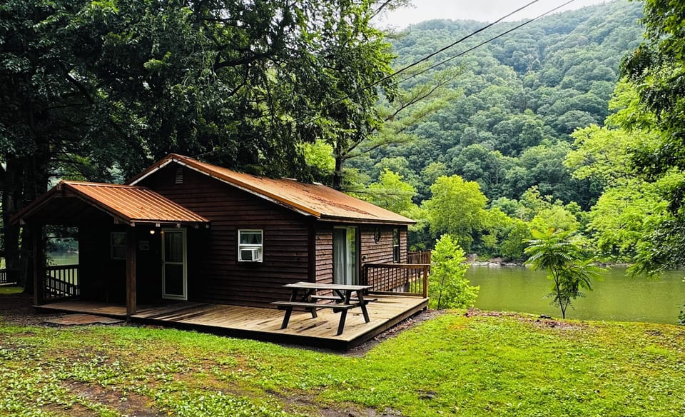 Side view of the cabin with river in the back round.