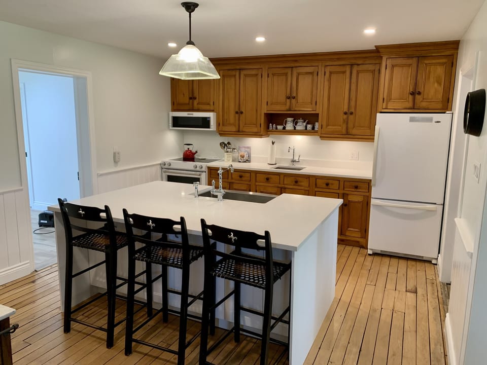 Newly updated country kitchen with large island for food prep and entertaining.