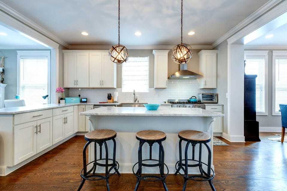 Fully equipped kitchen with a professional gas range and full-size refrigerator.