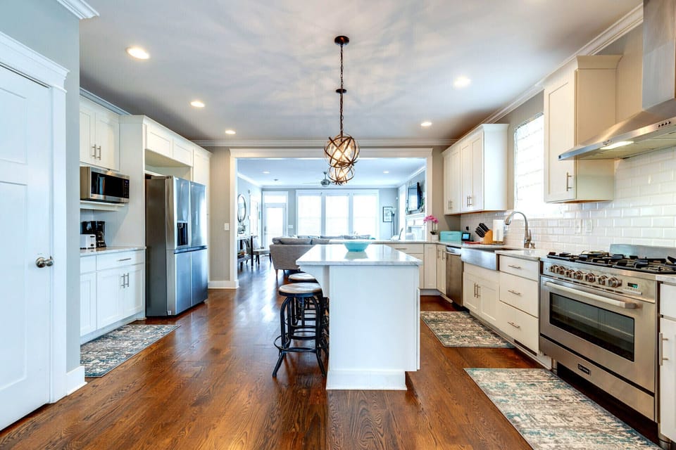 Spacious kitchen with a large island, professional gas range and plenty of room.