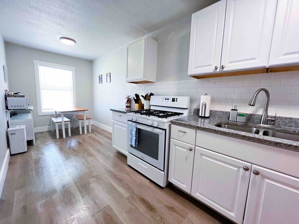 Discover a culinary paradise. Our kitchen is stocked with essentials like pots, pans, knives, cutting boards, and bakeware. Enjoy a gas stove, microwave, toaster, and a 12-cup coffee maker. Plus, enjoy complimentary coffee and sugar for a delicious morning.